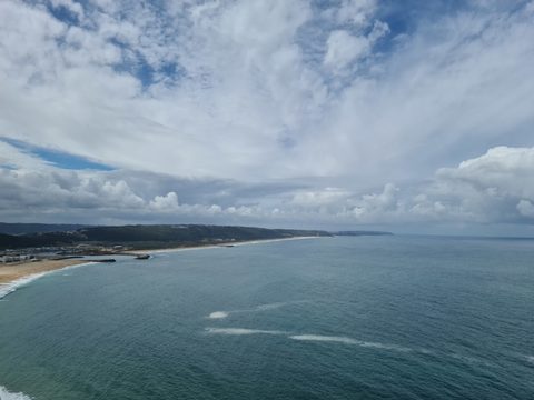 Aerial view of Nazaré town beach curving along the Atlantic coastline